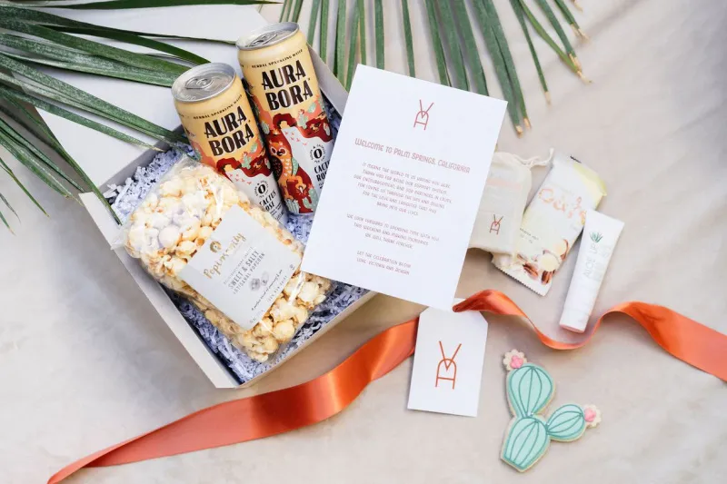   Victoria i Adrian's welcome boxes with popcorn, drinks, aloe, and cookies
