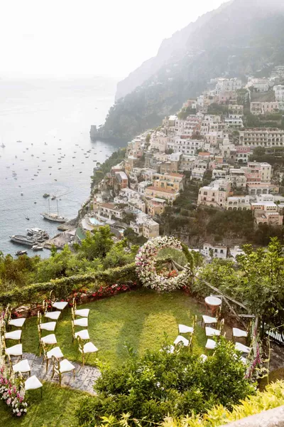   రోసా మరియు కీత్'s ceremony setup on the lawn overlooking the town of Amalfi
