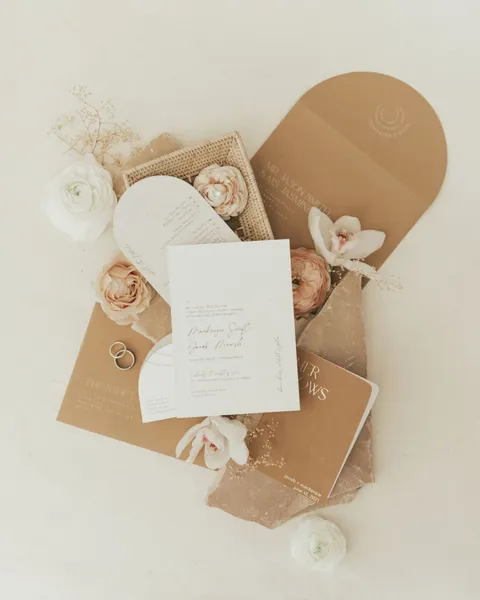   Kenzie i Jake's wedding invitations in brown and white tones